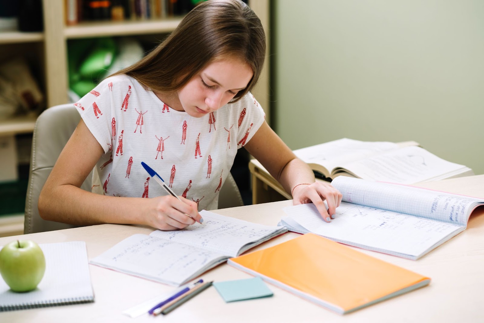 Female student writing math equations on paper