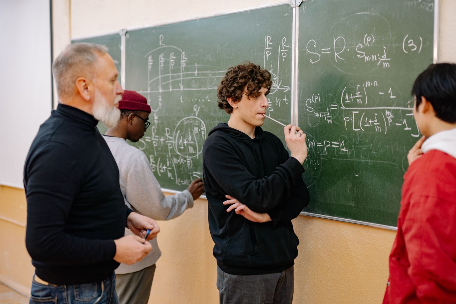 students solving equations on chalkboard