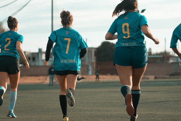 female students playing soccer